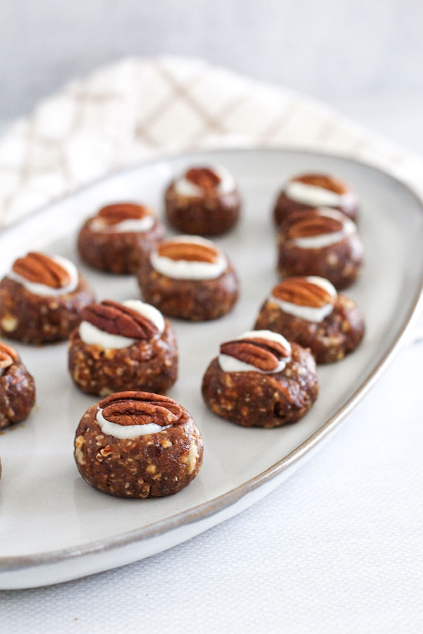 A close-up of the truffles on a plate, highlighting their texture and the glossy white chocolate pudding filling