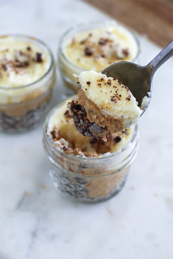 A spoonful of White Chocolate Caramel Wafer Gu Pot showing creamy white chocolate pudding, caramel, and chocolate hazelnut wafer layers
