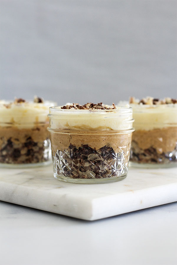 Three White Chocolate Caramel Wafer Gu Pots in glass jars, layered with chocolate hazelnut wafer crumble, caramel, and white chocolate pudding