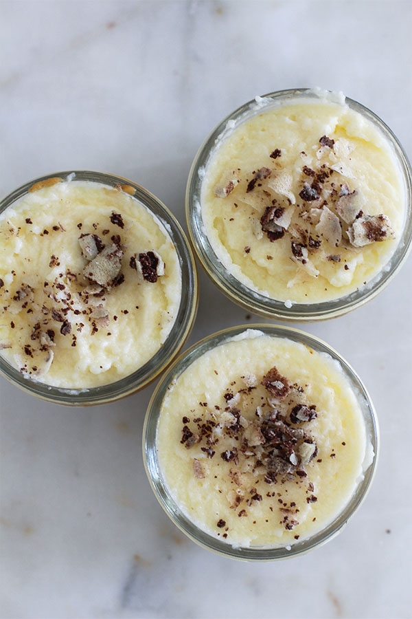 Top-down view of White Chocolate Caramel Wafer Gu Pots, garnished with crushed chocolate hazelnut wafers