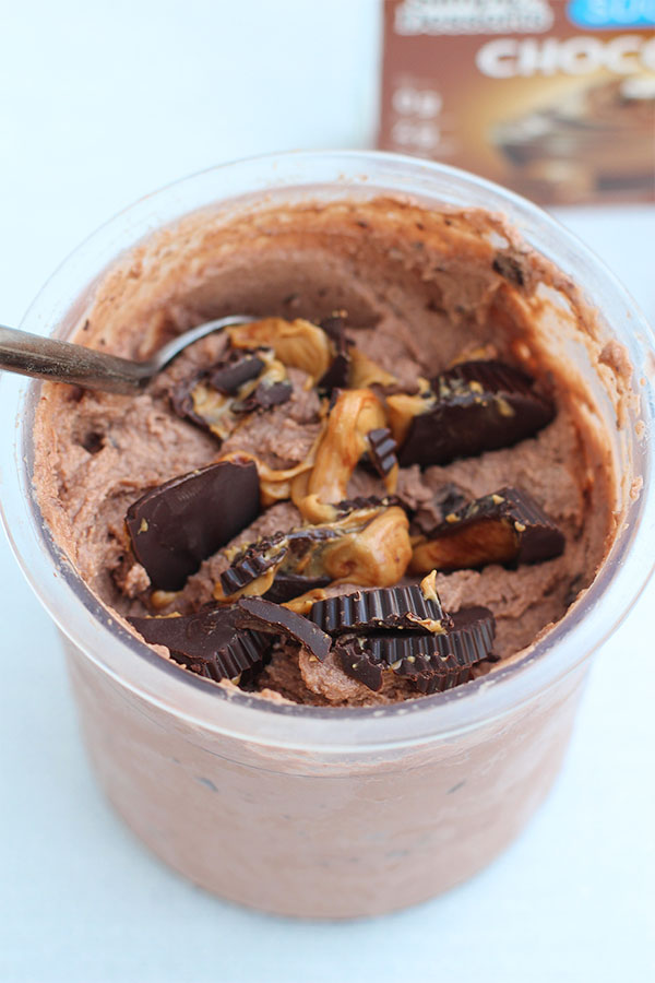 Chocolate peanut butter ice cream in a cup with spoon