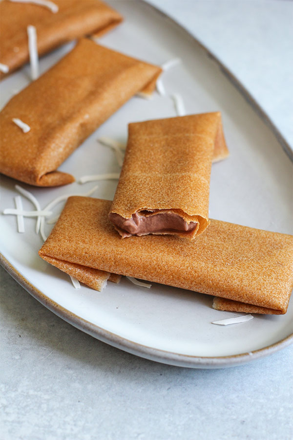 Close-up of a coconut wrap filled with chocolate pudding ice cream, showing the creamy inside