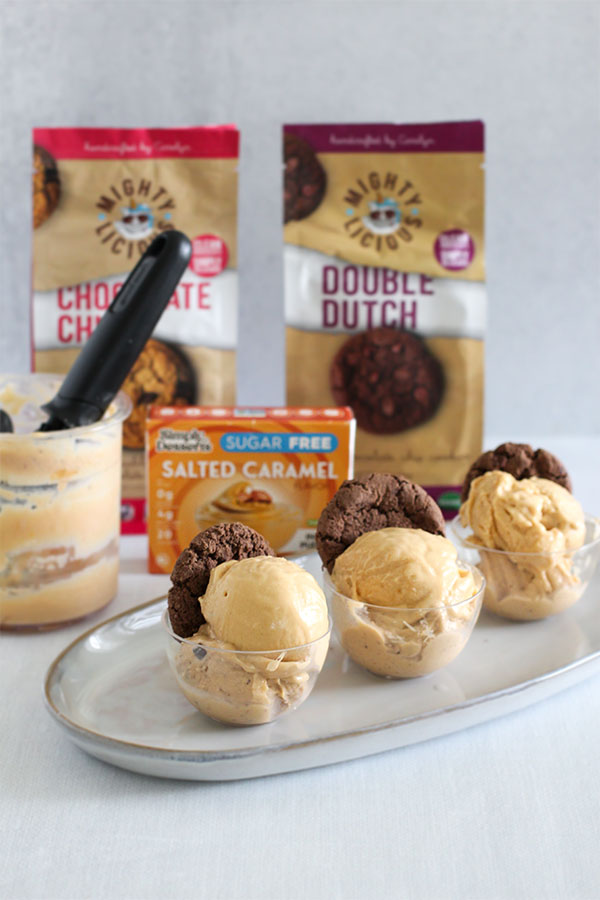 individual dessert cups of sugar free salted caramel ice cream topped with mightylicious chocolate cookies on a serving tray