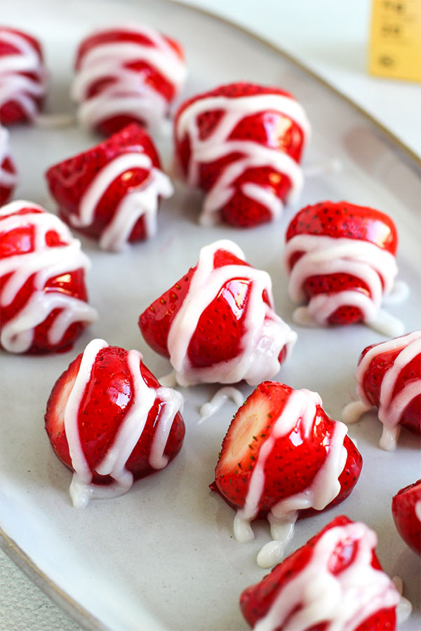 Fresh strawberries coated in candy and drizzled with sugar-free white chocolate pudding