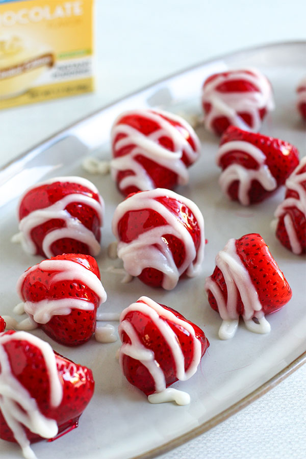 Close-up of candy-coated strawberries with sugar-free white chocolate drizzle