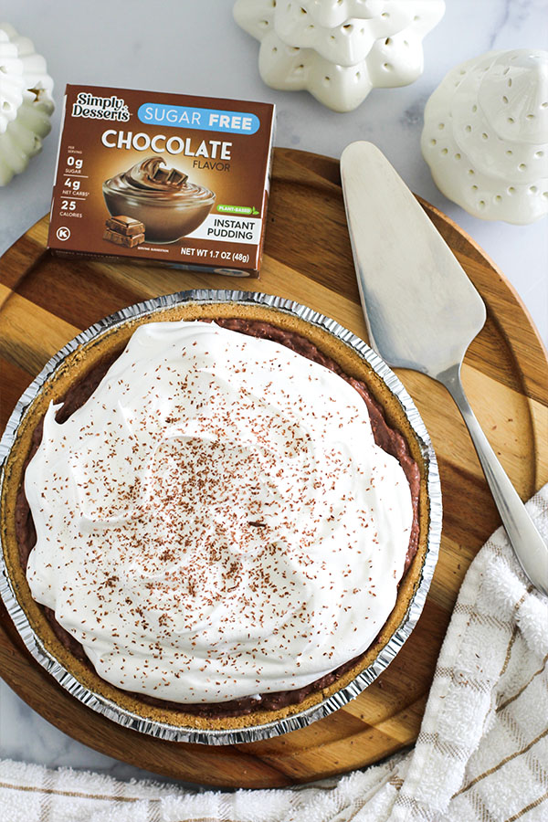 Overhead view of chocolate silk pie with whipped topping and chocolate shavings