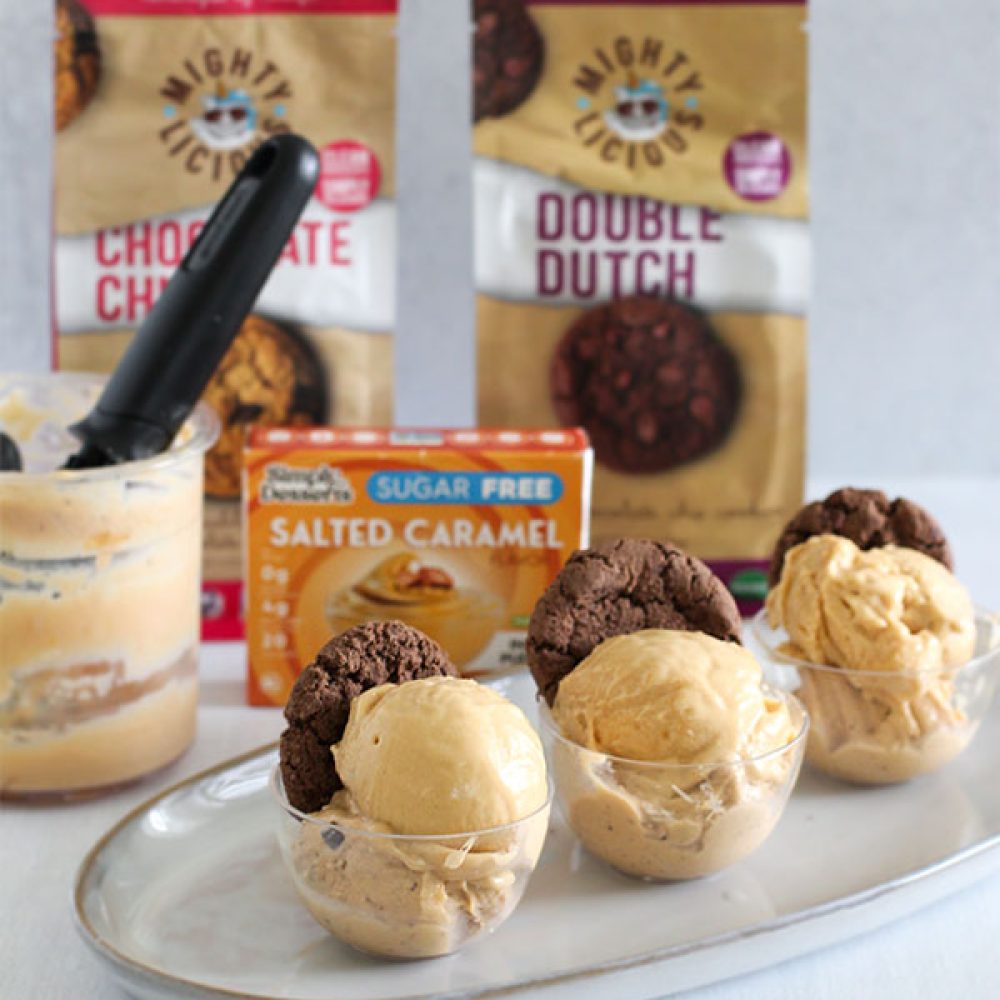 individual dessert cups of sugar free salted caramel ice cream topped with mightylicious chocolate cookies on a serving tray